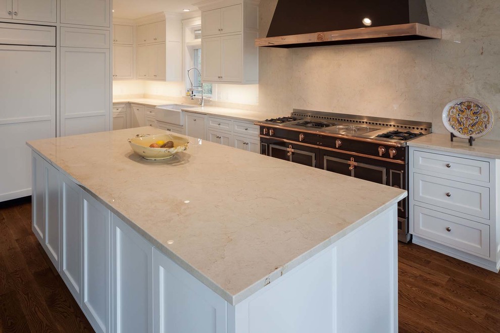 Kitchen - large transitional light wood floor kitchen idea with a drop-in sink, recessed-panel cabinets, white cabinets, marble countertops, glass tile backsplash and stainless steel appliances