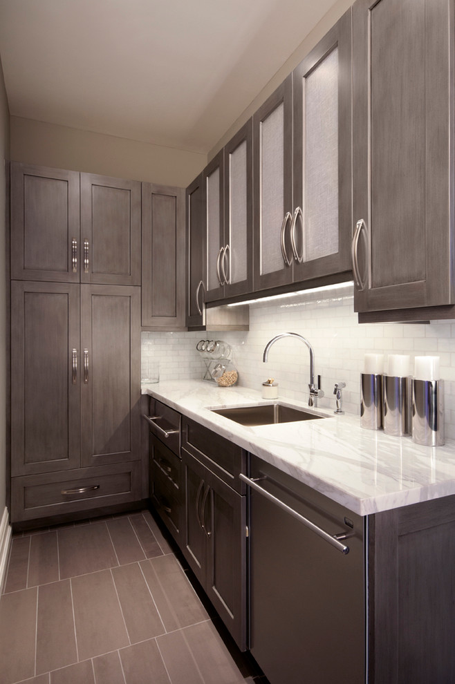 This is an example of a mid-sized traditional l-shaped separate kitchen in Miami with an undermount sink, shaker cabinets, marble benchtops, white splashback, subway tile splashback, stainless steel appliances and grey cabinets.