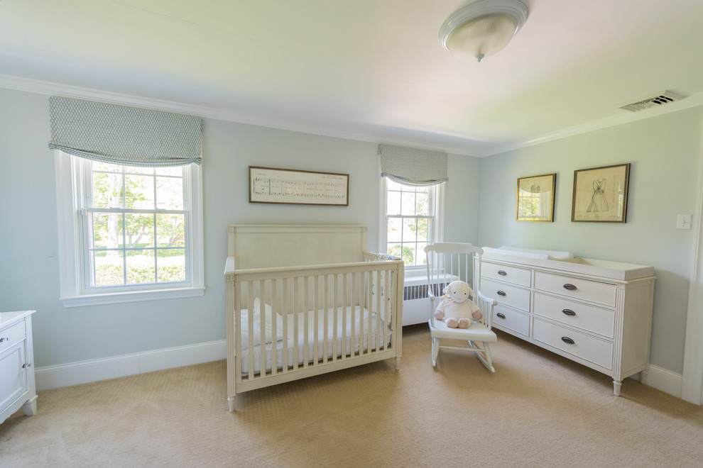 Photo of a mid-sized transitional nursery in Philadelphia with blue walls, carpet and beige floor.