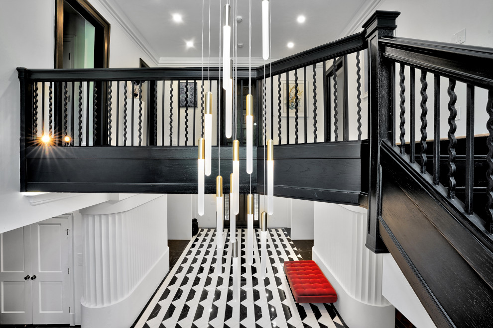 Custom Dark Wood Staircase with Cascading Pendant Chandelier – Historic Renovati