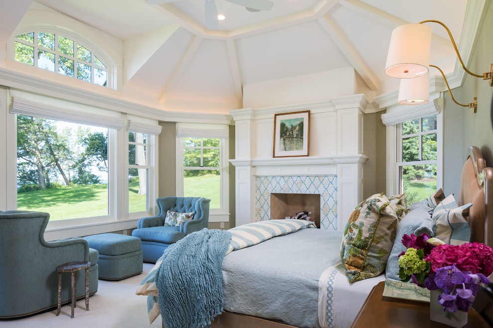 Design ideas for a traditional master bedroom in Minneapolis with a standard fireplace and a tile fireplace surround.
