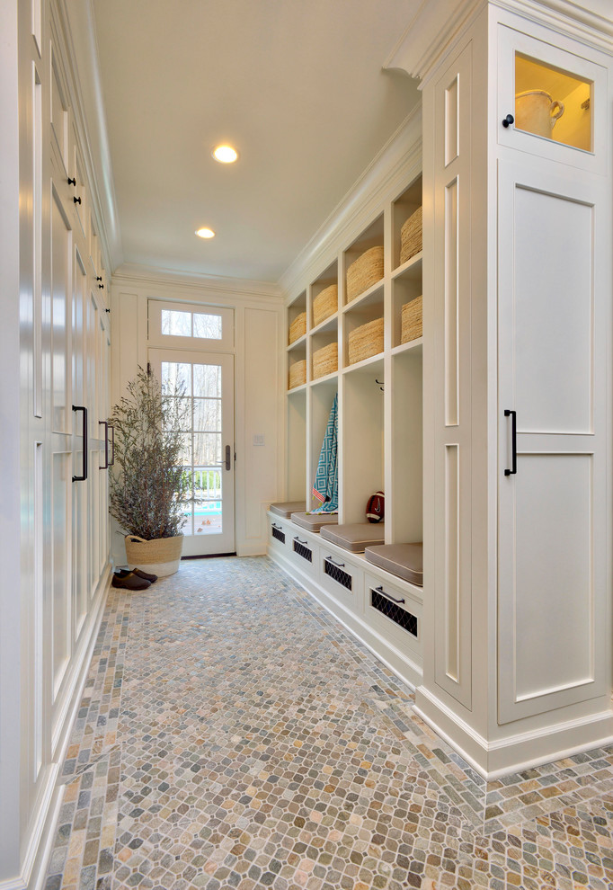 Design ideas for an expansive traditional mudroom in New York with white walls, porcelain floors, a single front door, a white front door and multi-coloured floor.