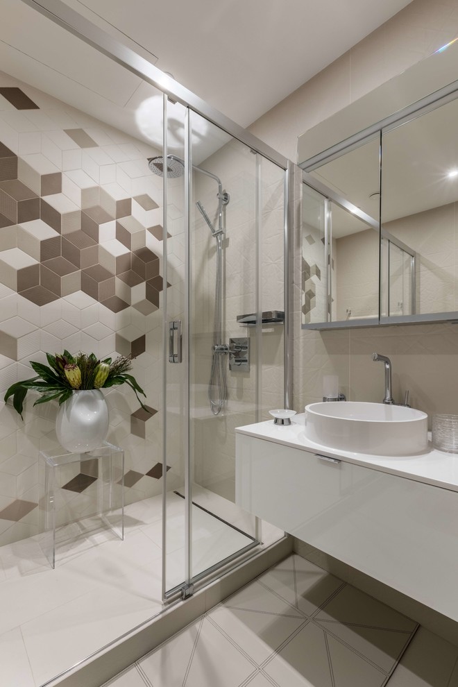 Photo of a contemporary 3/4 bathroom in Moscow with flat-panel cabinets, white cabinets, beige tile, white tile, brown tile, a vessel sink and a sliding shower screen.