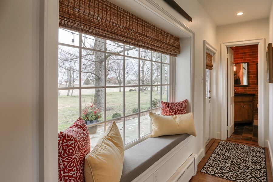 Example of a mid-sized transitional medium tone wood floor front door design with white walls and a white front door