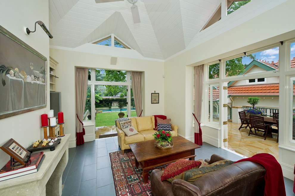 This is an example of a mid-sized country enclosed family room in Melbourne with beige walls, ceramic floors and no tv.