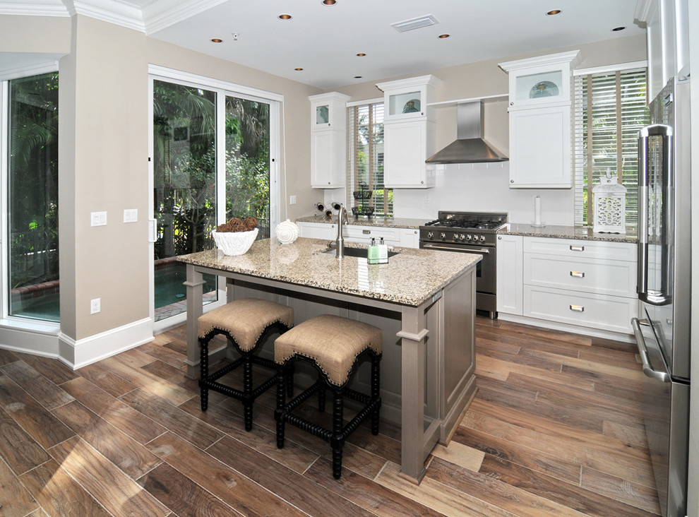 Design ideas for a traditional kitchen in Miami with stainless steel appliances and white splashback.