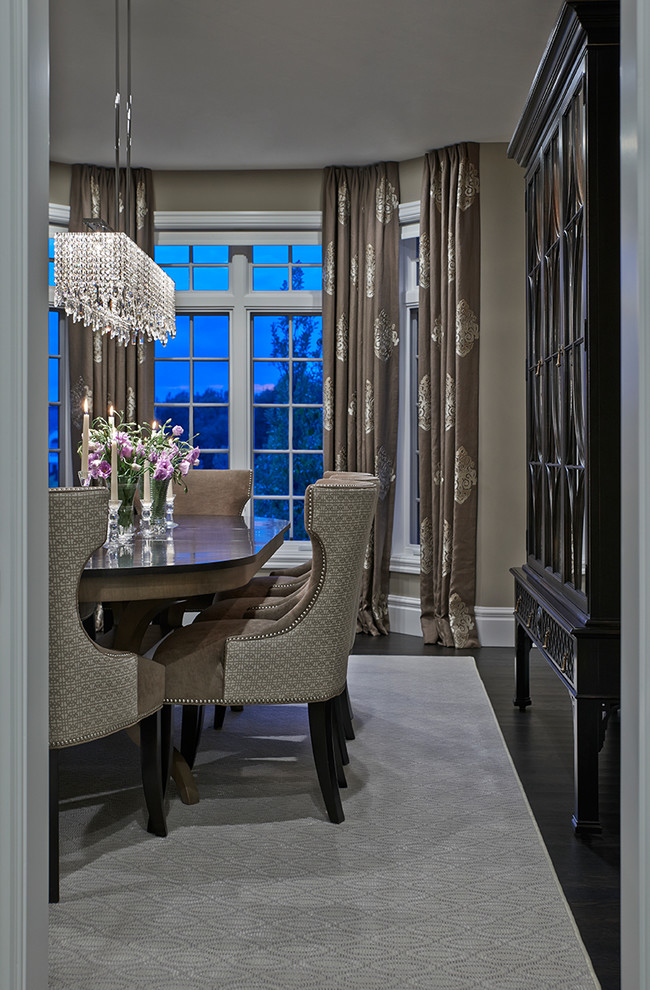 This is an example of a large transitional separate dining room in Detroit with beige walls and dark hardwood floors.