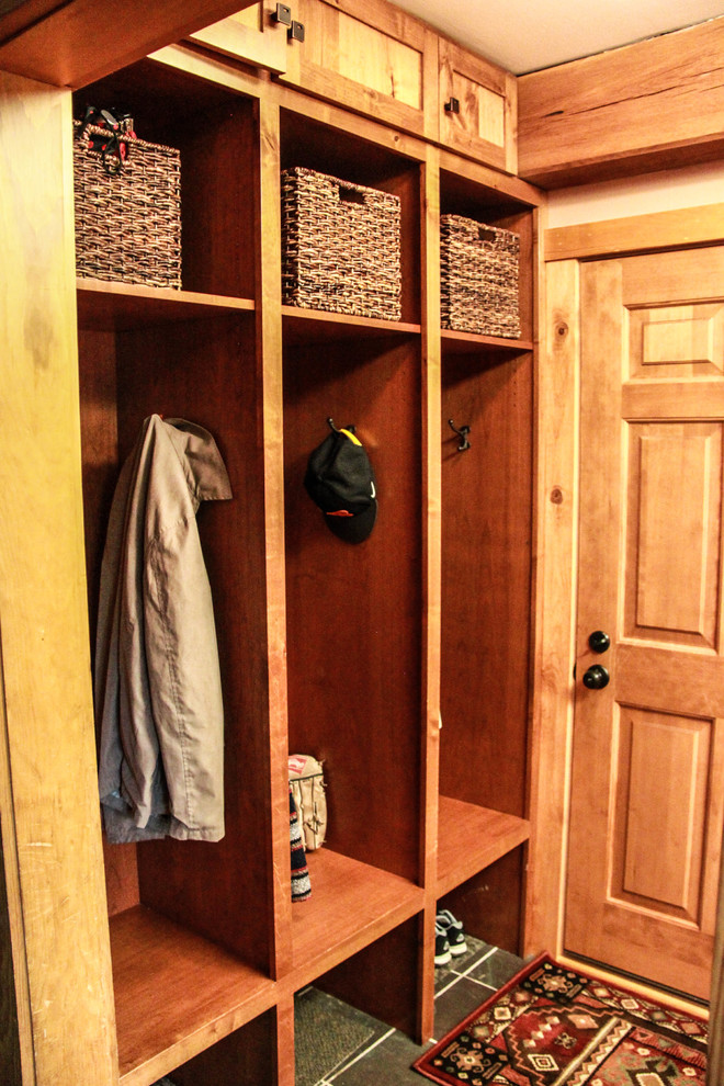 Photo of a small country mudroom in Milwaukee with beige walls, slate floors, a single front door, a medium wood front door and green floor.