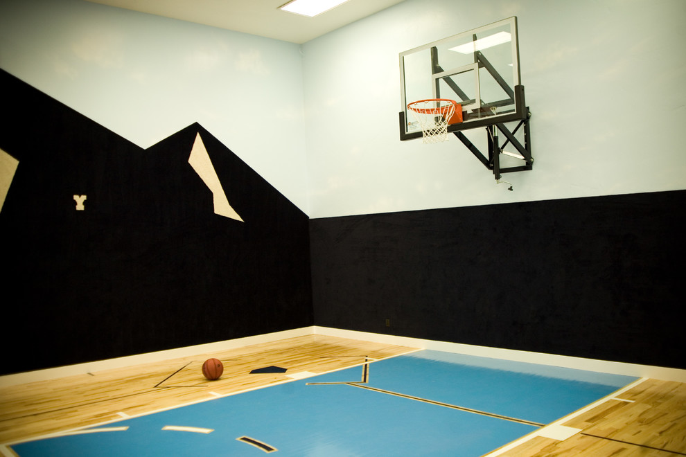This is an example of a large transitional home gym in Salt Lake City with multi-coloured walls and plywood floors.