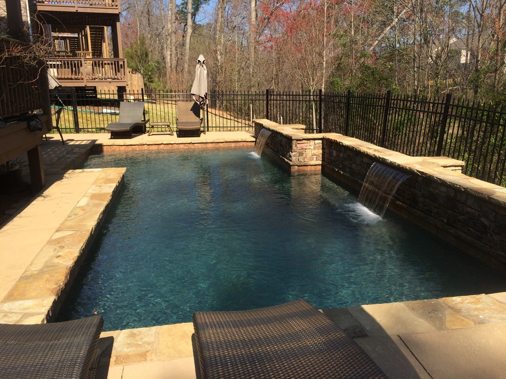 Small traditional backyard custom-shaped natural pool in Atlanta with a water feature and decking.