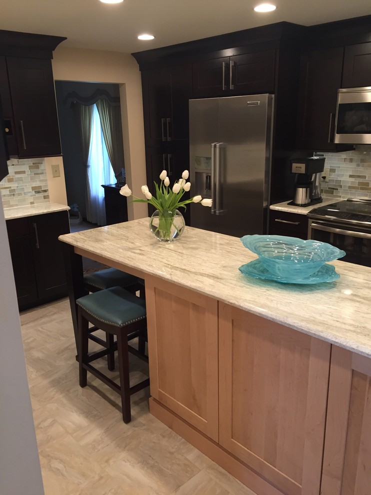 Example of a transitional ceramic tile kitchen design with a single-bowl sink, dark wood cabinets, multicolored backsplash, mosaic tile backsplash, stainless steel appliances and an island