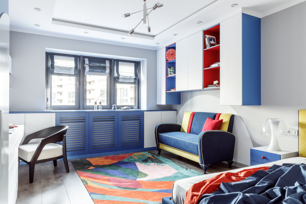 This is an example of a large contemporary gender-neutral kids' room in Other with medium hardwood floors, recessed, wallpaper, grey walls and grey floor.