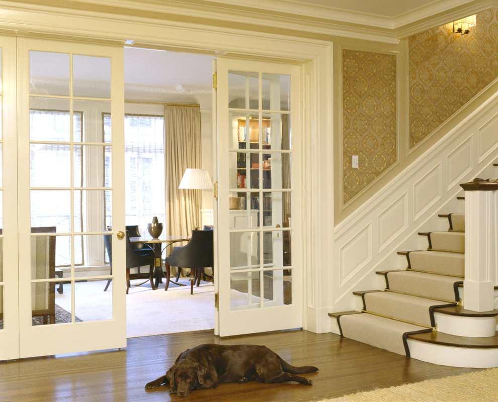 Inspiration for a large medium tone wood floor and brown floor foyer remodel in San Francisco with beige walls