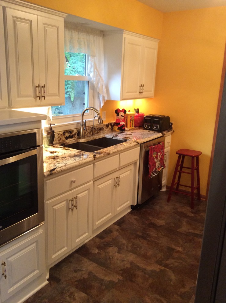Example of a huge kitchen design in Minneapolis with an undermount sink and stainless steel appliances