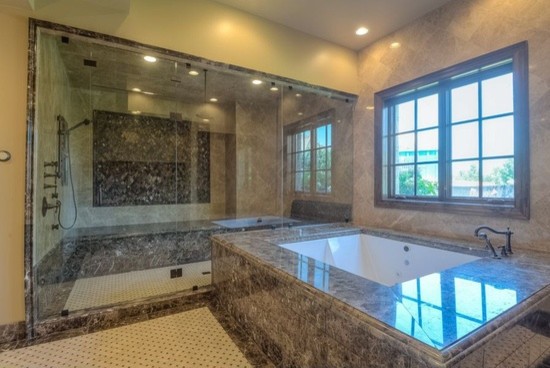 Inspiration for a huge transitional master white tile and porcelain tile porcelain tile drop-in bathtub remodel in Phoenix with flat-panel cabinets, medium tone wood cabinets, a one-piece toilet, beige walls, a drop-in sink and granite countertops