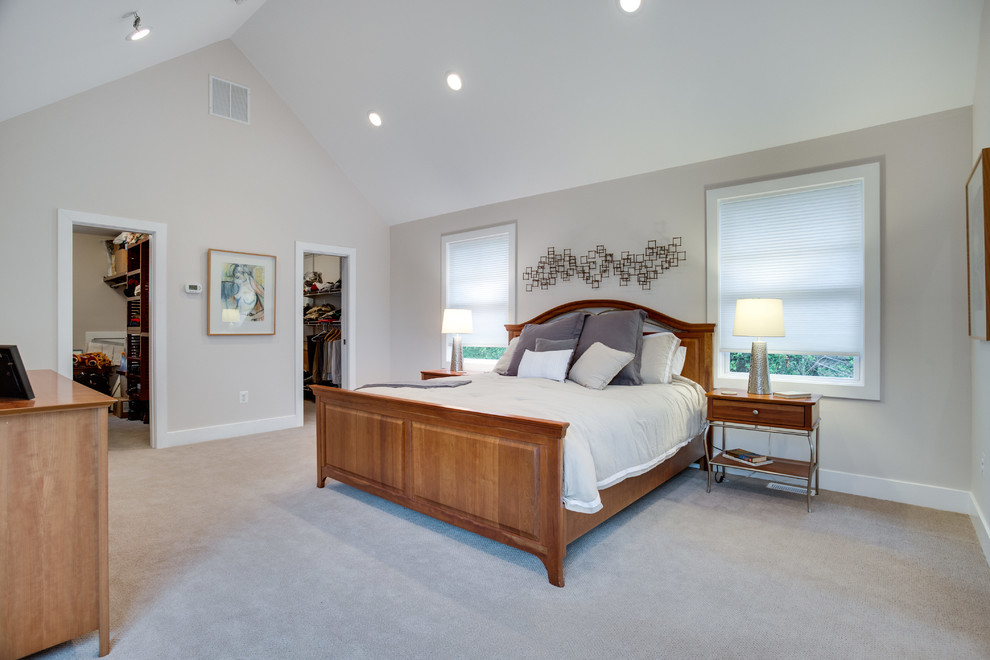 This is an example of a mid-sized arts and crafts master bedroom in Baltimore with white walls, medium hardwood floors and no fireplace.