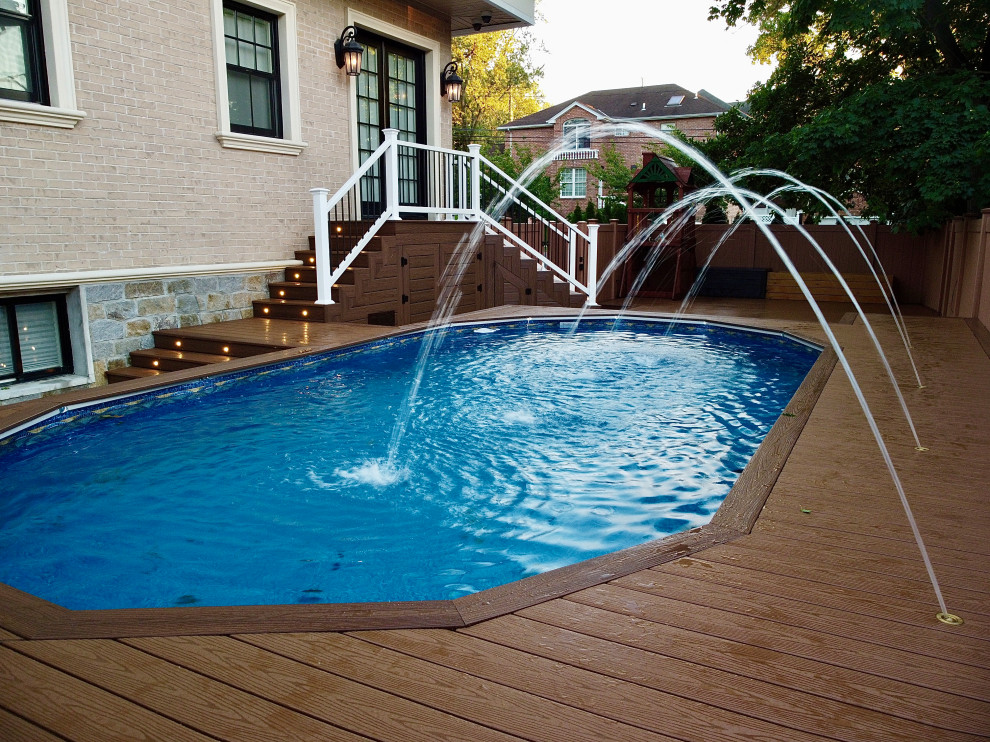 Inspiration for a large traditional backyard custom-shaped aboveground pool in New York with a water feature and decking.