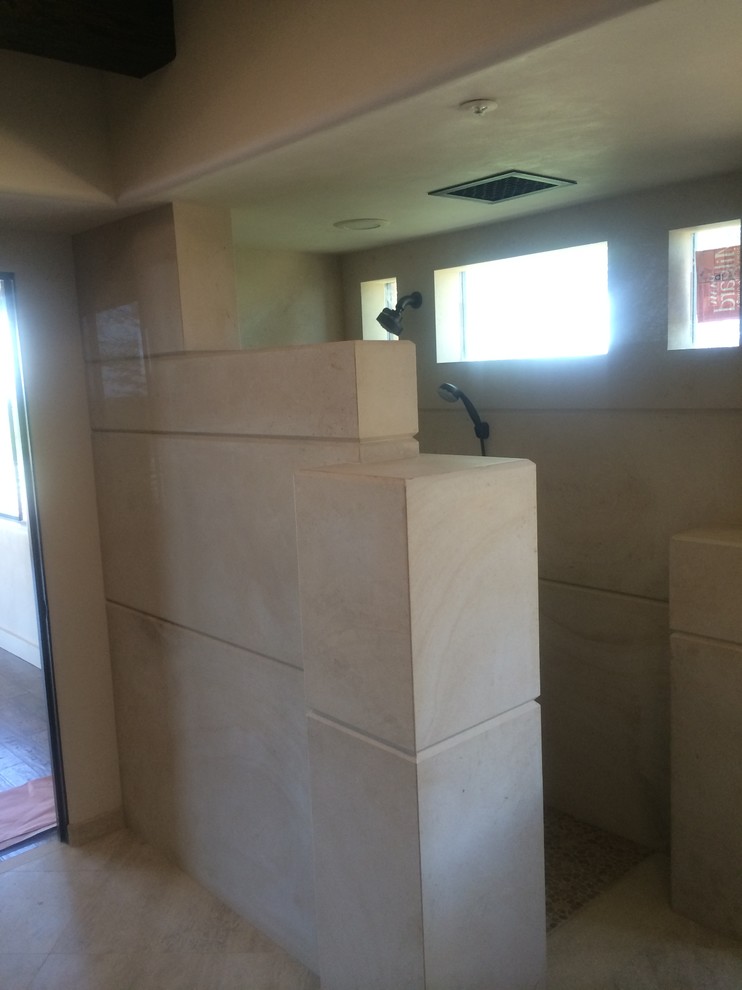 Example of a transitional master beige tile and stone tile limestone floor doorless shower design in Phoenix with beige walls