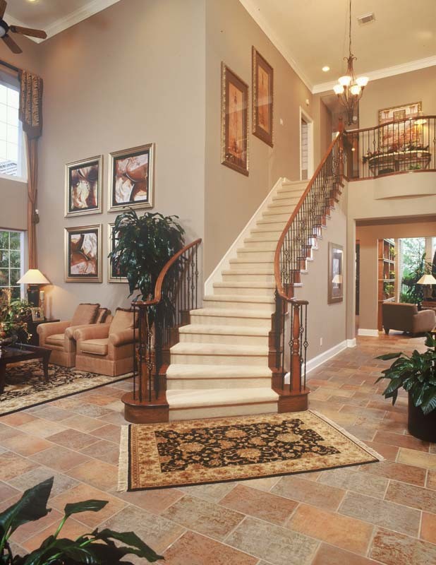 Staircase - large traditional carpeted floating ceramic tile staircase idea in Salt Lake City with beige walls and carpeted risers
