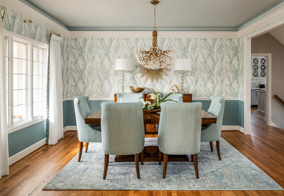 This is an example of a mid-sized traditional dining room in Other with blue walls, medium hardwood floors, brown floor and wallpaper.