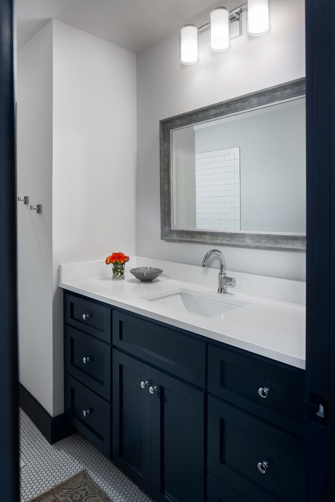 Inspiration for a small transitional kids bathroom in Birmingham with recessed-panel cabinets, blue cabinets, an alcove tub, a shower/bathtub combo, a two-piece toilet, white tile, ceramic tile, white walls, ceramic floors, an undermount sink, engineered quartz benchtops, grey floor, a shower curtain and white benchtops.