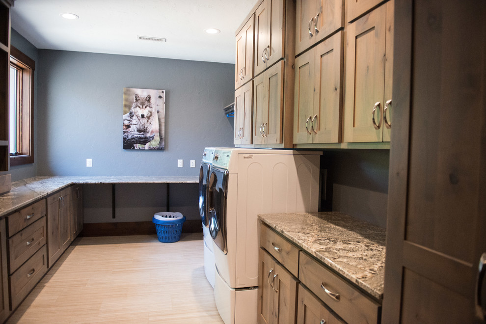 Utility room - huge rustic u-shaped gray floor utility room idea with an undermount sink, flat-panel cabinets, light wood cabinets, granite countertops, blue walls, a side-by-side washer/dryer and multicolored countertops