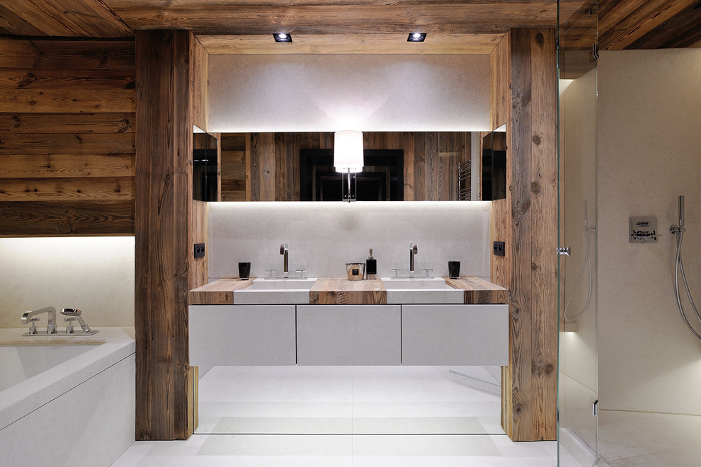 Design ideas for a country master bathroom in Lyon with flat-panel cabinets, white cabinets, an undermount tub, a corner shower, beige walls, an undermount sink, wood benchtops, white tile and a hinged shower door.