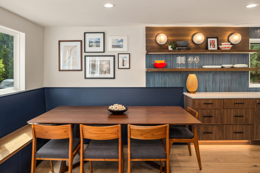 Great room - large contemporary light wood floor and brown floor great room idea in Seattle with blue walls and no fireplace