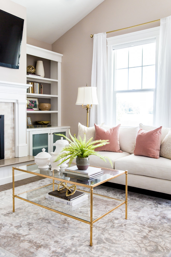 Inspiration for a mid-sized traditional open concept living room in Salt Lake City with pink walls, a tile fireplace surround, a wall-mounted tv and grey floor.