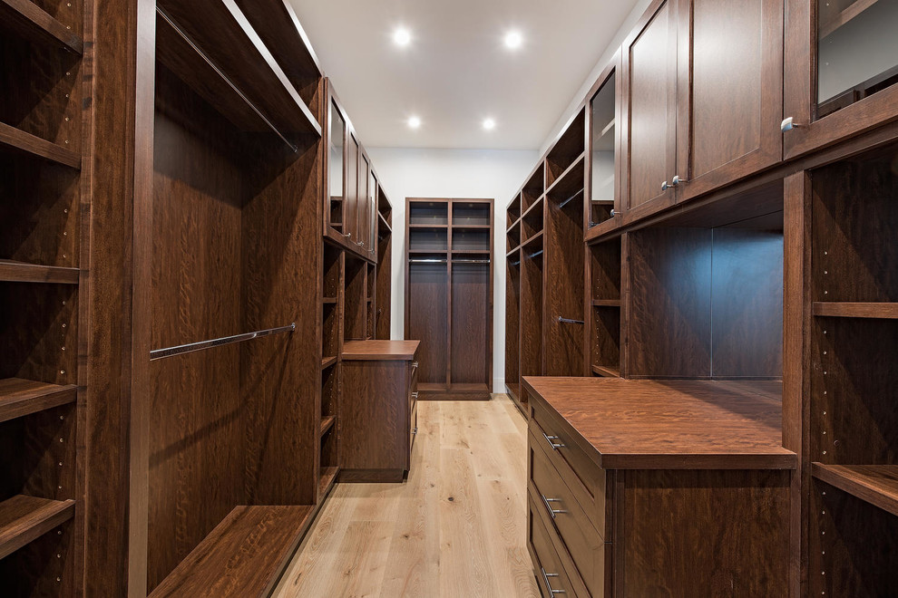 Inspiration for a small transitional gender-neutral walk-in wardrobe in Miami with shaker cabinets and medium wood cabinets.