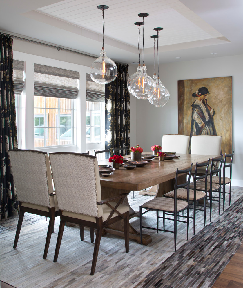This is an example of a transitional separate dining room in Denver with grey walls, dark hardwood floors and brown floor.