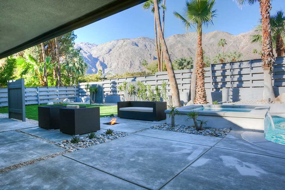 This is an example of a mid-sized midcentury backyard patio in Los Angeles with concrete pavers.