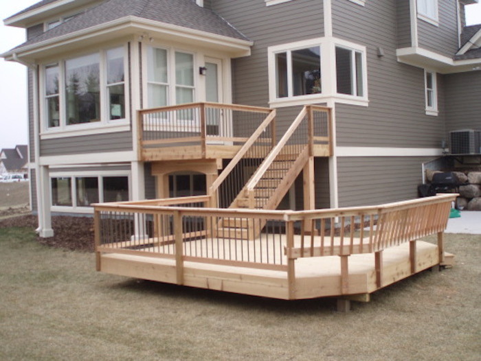 Photo of a large arts and crafts backyard deck in Minneapolis with no cover.