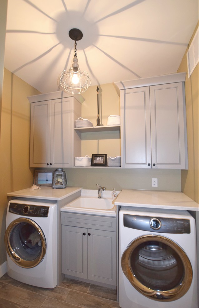Design ideas for a small traditional single-wall dedicated laundry room in Denver with a drop-in sink, raised-panel cabinets, grey cabinets and an integrated washer and dryer.