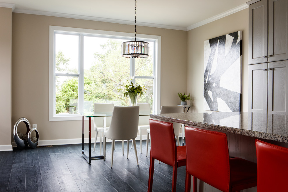 This is an example of an eclectic open plan dining in Other with beige walls, laminate floors and black floor.