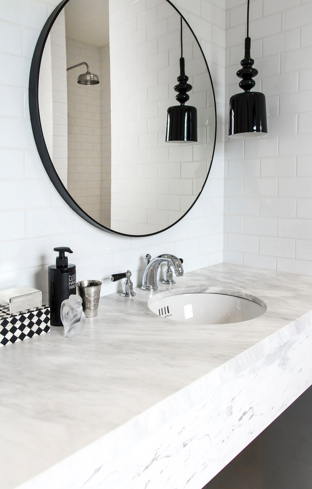 Mid-sized traditional master bathroom in Sydney with furniture-like cabinets, black cabinets, an open shower, a wall-mount toilet, white tile, porcelain tile, white walls, marble floors, an undermount sink and marble benchtops.