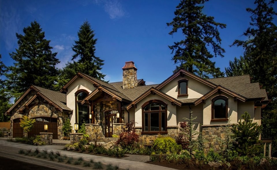 This is an example of a large traditional two-storey exterior in Portland with a gable roof.