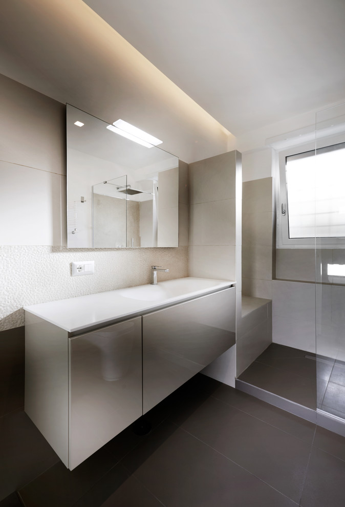 This is an example of a small contemporary bathroom in Rome with a bidet, white walls, ceramic floors and an integrated sink.