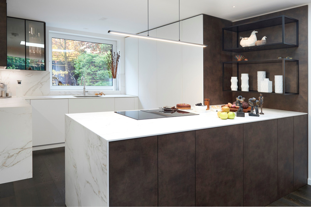 Contemporary u-shaped kitchen in London with an undermount sink, flat-panel cabinets, white cabinets, dark hardwood floors, a peninsula, brown floor and white benchtop.
