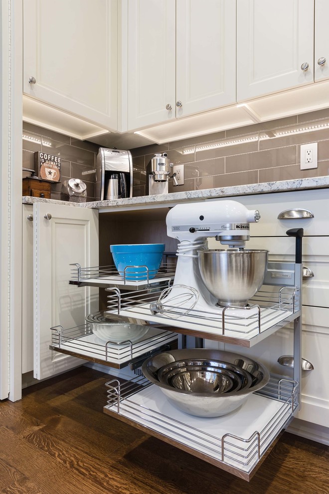 This is an example of a traditional kitchen in Other with white cabinets and stainless steel appliances.