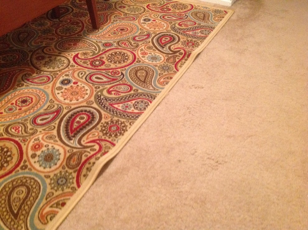How to keep area rug on carpet flat?