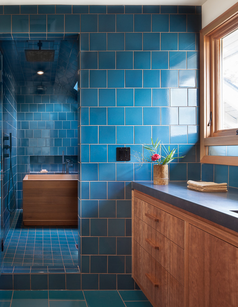 Design ideas for a small modern master wet room bathroom in Portland with flat-panel cabinets, medium wood cabinets, a japanese tub, blue tile, ceramic tile, blue walls, ceramic floors, an integrated sink, quartzite benchtops, blue floor and a hinged shower door.