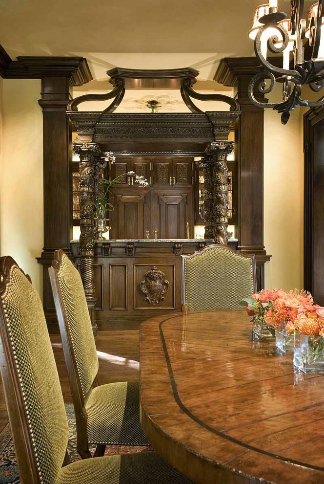 This is an example of a mediterranean dining room in Dallas with dark hardwood floors.