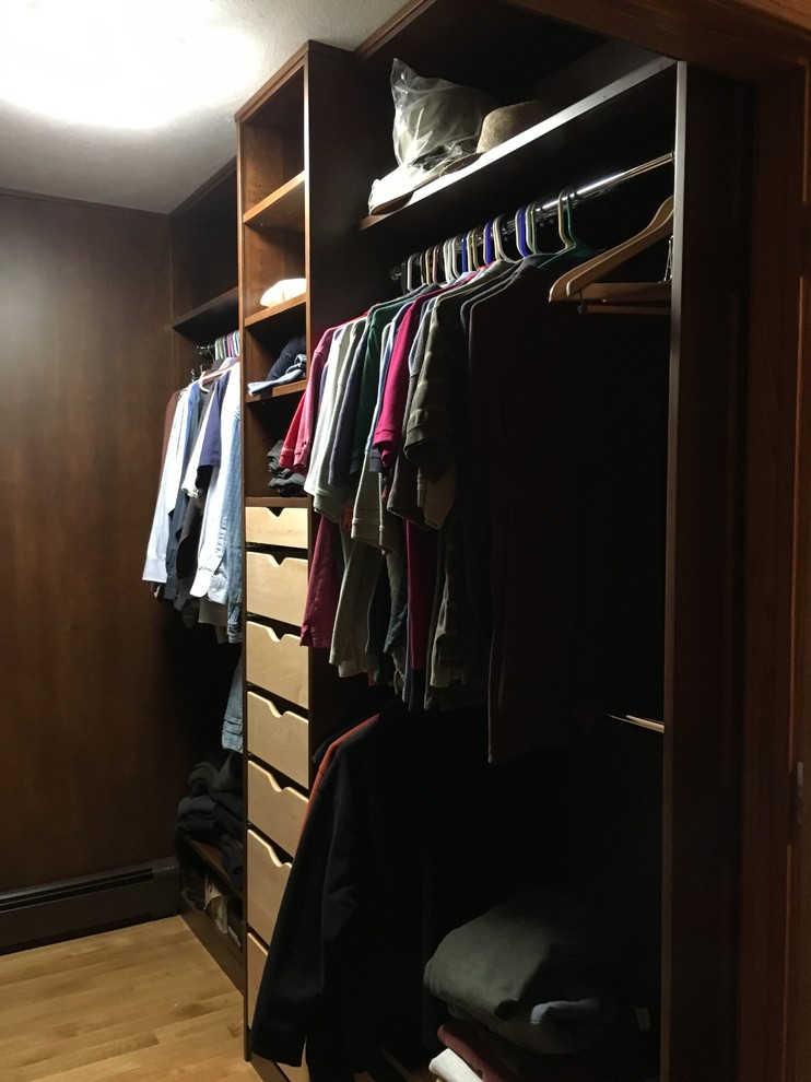 Mid-sized transitional light wood floor walk-in closet photo with open cabinets and dark wood cabinets