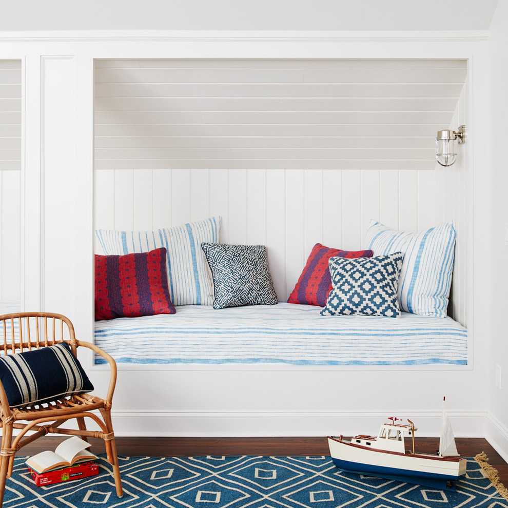 Inspiration for a large beach style gender-neutral kids' bedroom for kids 4-10 years old in Jacksonville with white walls, dark hardwood floors and brown floor.