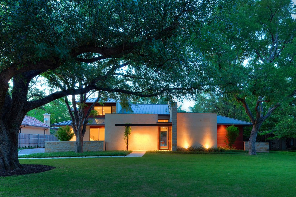 This is an example of a contemporary two-storey exterior in Dallas with a hip roof.