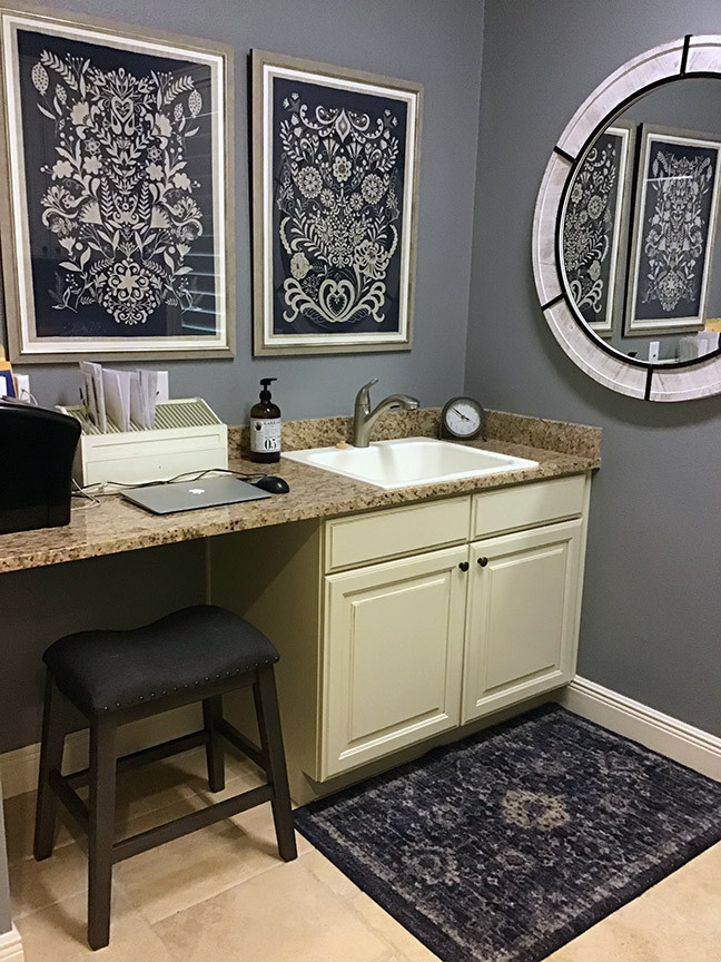 Design ideas for a mid-sized transitional galley utility room in Orlando with a drop-in sink, raised-panel cabinets, white cabinets, granite benchtops, blue walls, travertine floors, beige floor and multi-coloured benchtop.