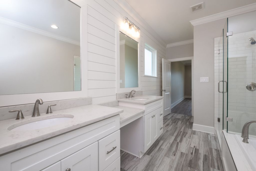 Inspiration for a mid-sized country master gray tile and ceramic tile porcelain tile, multicolored floor, double-sink and shiplap wall bathroom remodel in Little Rock with shaker cabinets, white cabinets, a one-piece toilet, gray walls, an undermount sink, quartz countertops, a hinged shower door, white countertops and a built-in vanity
