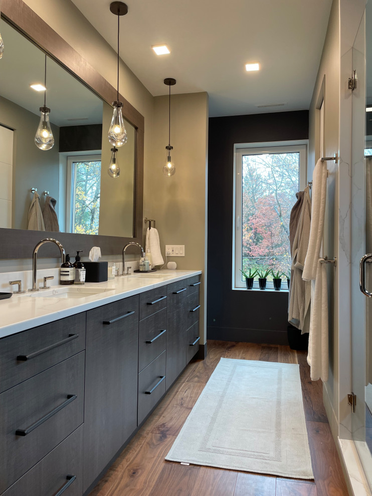 Large contemporary master bathroom in Other with flat-panel cabinets, brown cabinets, a double shower, a bidet, stone slab, grey walls, medium hardwood floors, an undermount sink, engineered quartz benchtops, brown floor, a hinged shower door, white benchtops, an enclosed toilet, a double vanity and a built-in vanity.