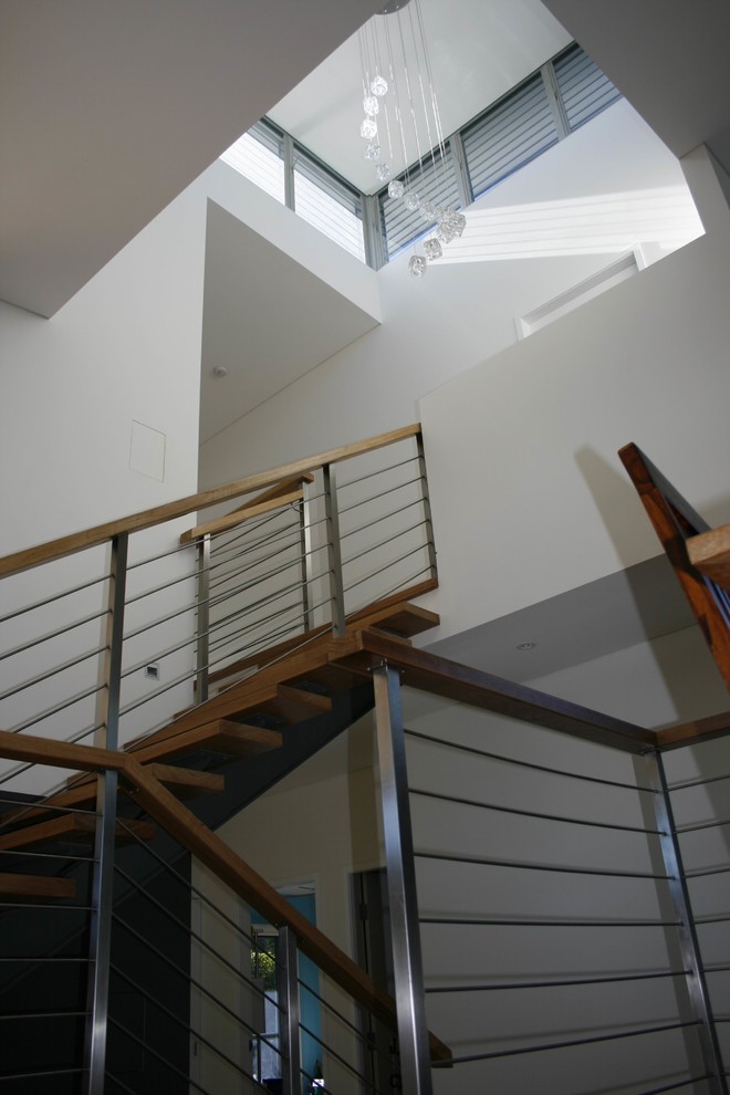 This is an example of a mid-sized contemporary wood straight staircase in Sydney with open risers.